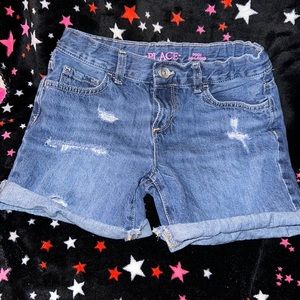 Gently worn distressed girls denim midi shorts